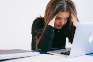 IndiaWorld IndiaWorld A stressed woman at a desk, looking at a laptop with a worried expression. A stressed woman at a desk, looking at a laptop with a worried expression.