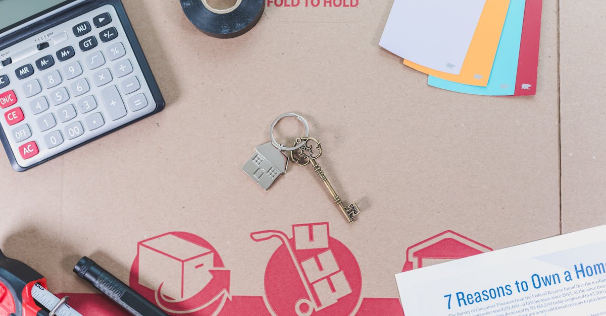 IndiaWorld IndiaWorld Flat lay of home buying essentials with calculator, keys, tape, and color swatches. Flat lay of home buying essentials with calculator, keys, tape, and color swatches.